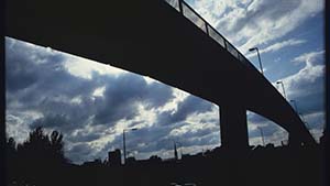 Silhouetted overpass against clouded sky